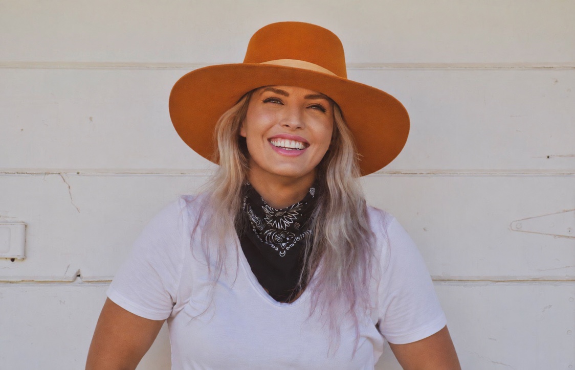 Ashlee Bond smiling in an orange hat