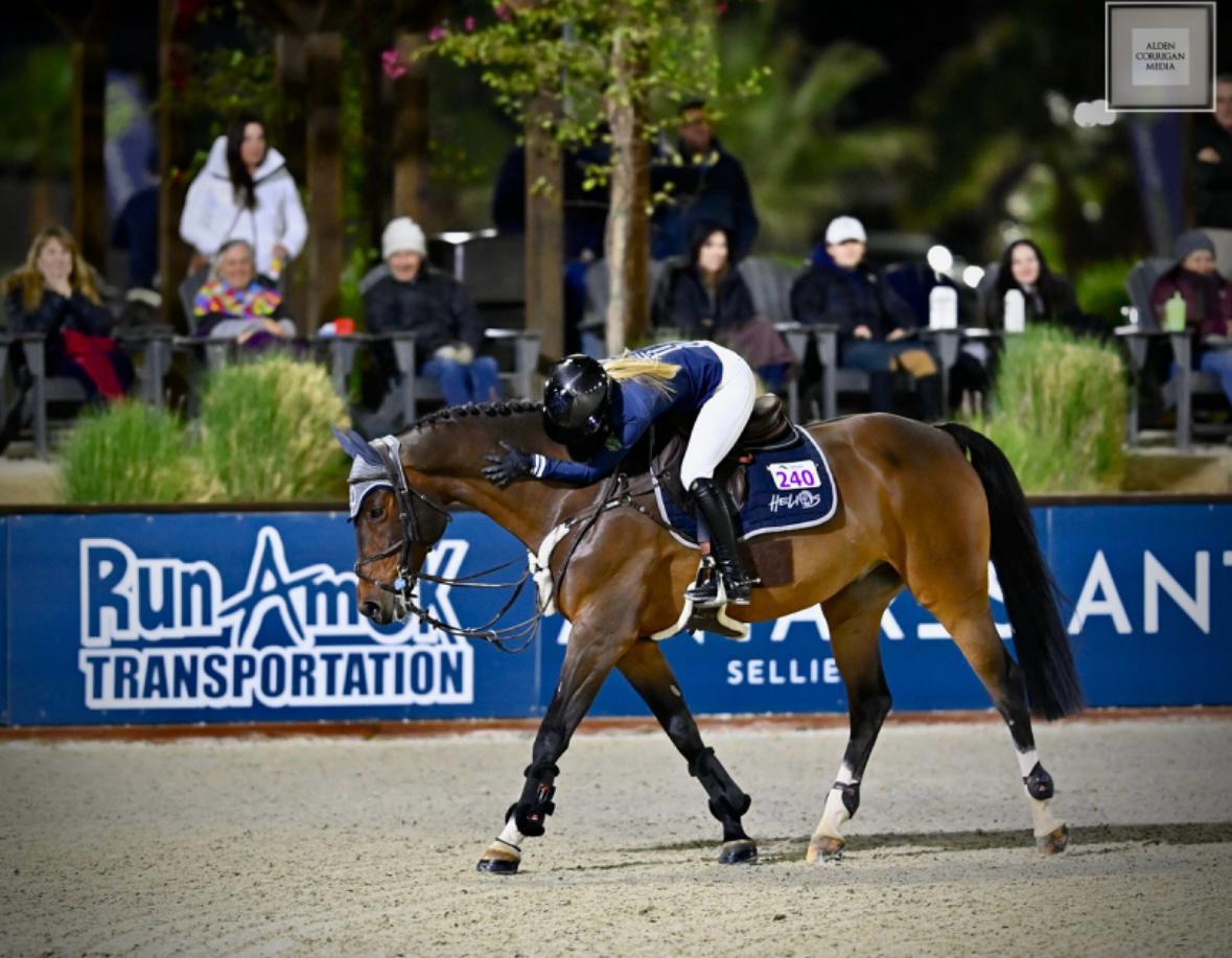 Ashlee patting her horse after a round