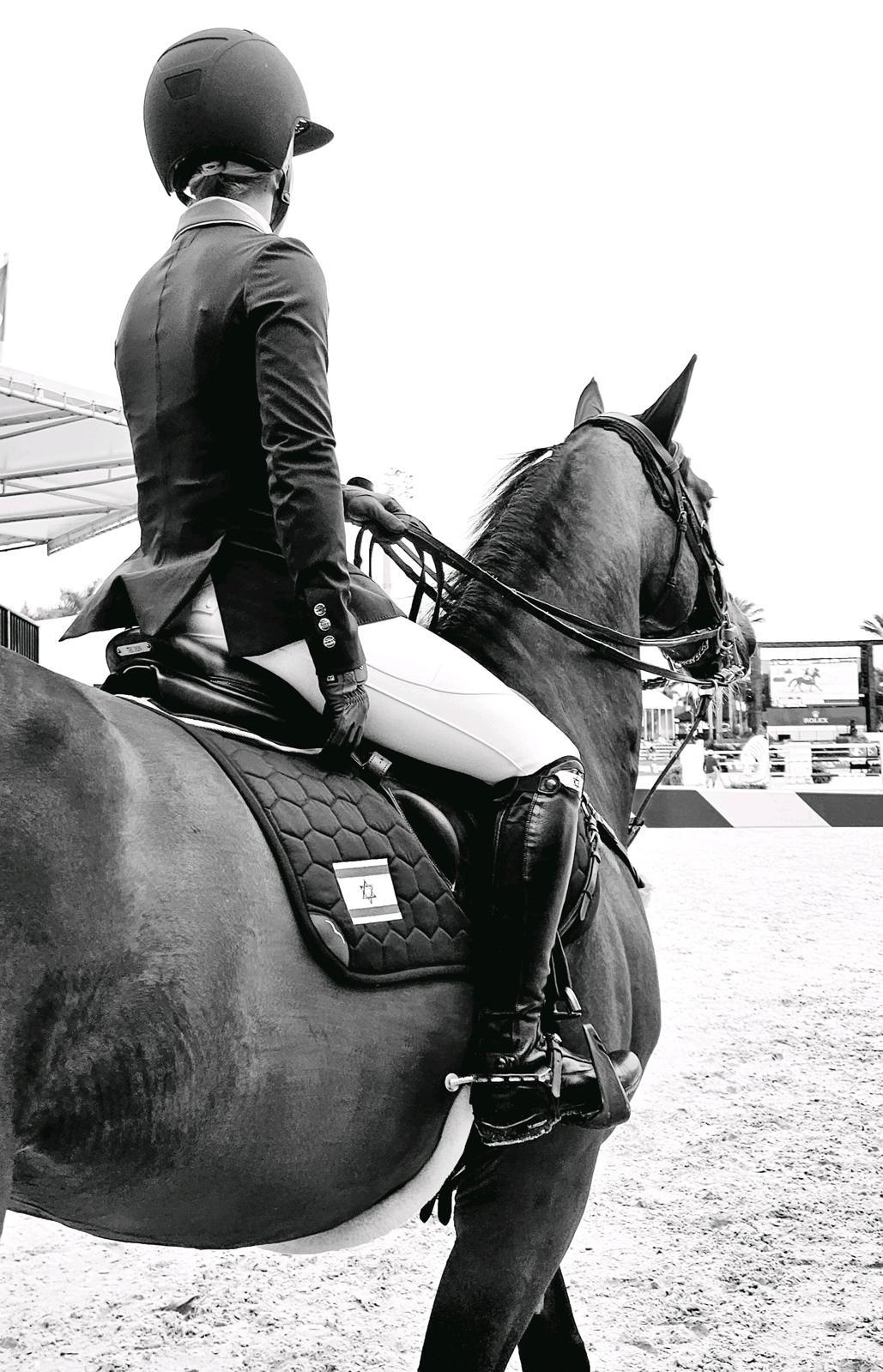 Black and white photograph of Ashlee waiting on horseback