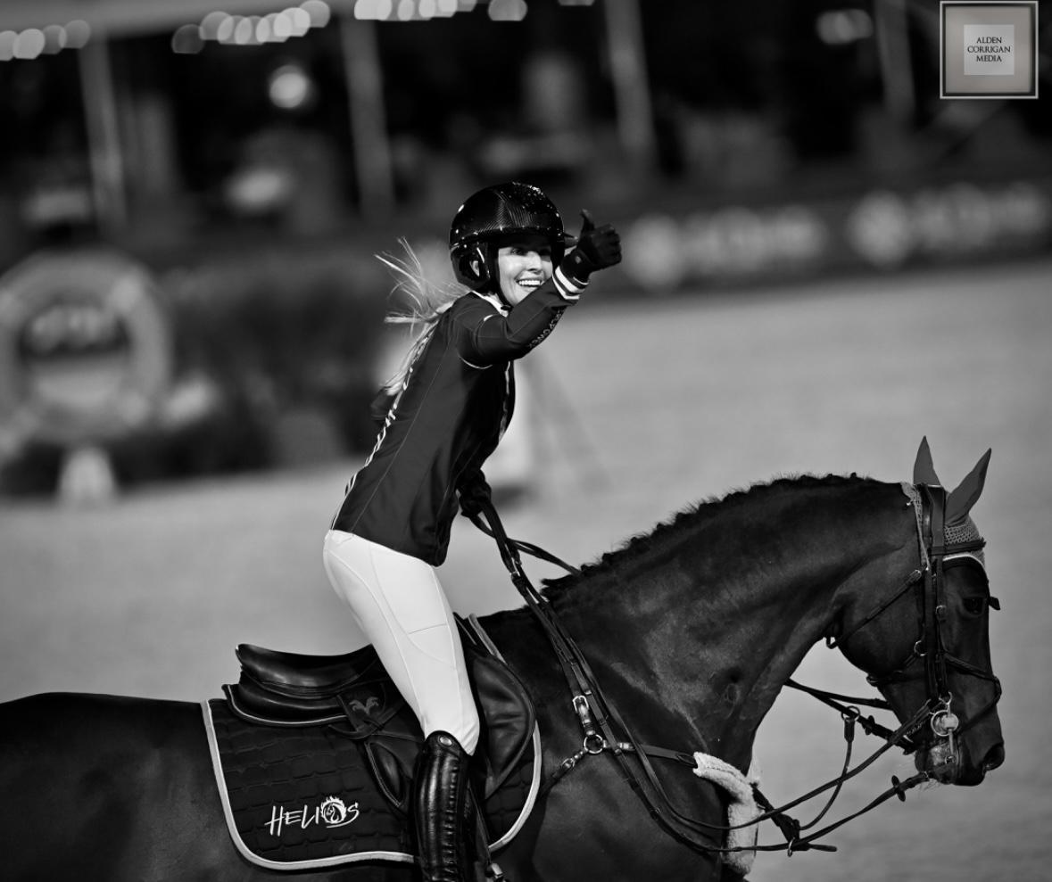 Black and white photograph of Ashlee celebrating on horseback