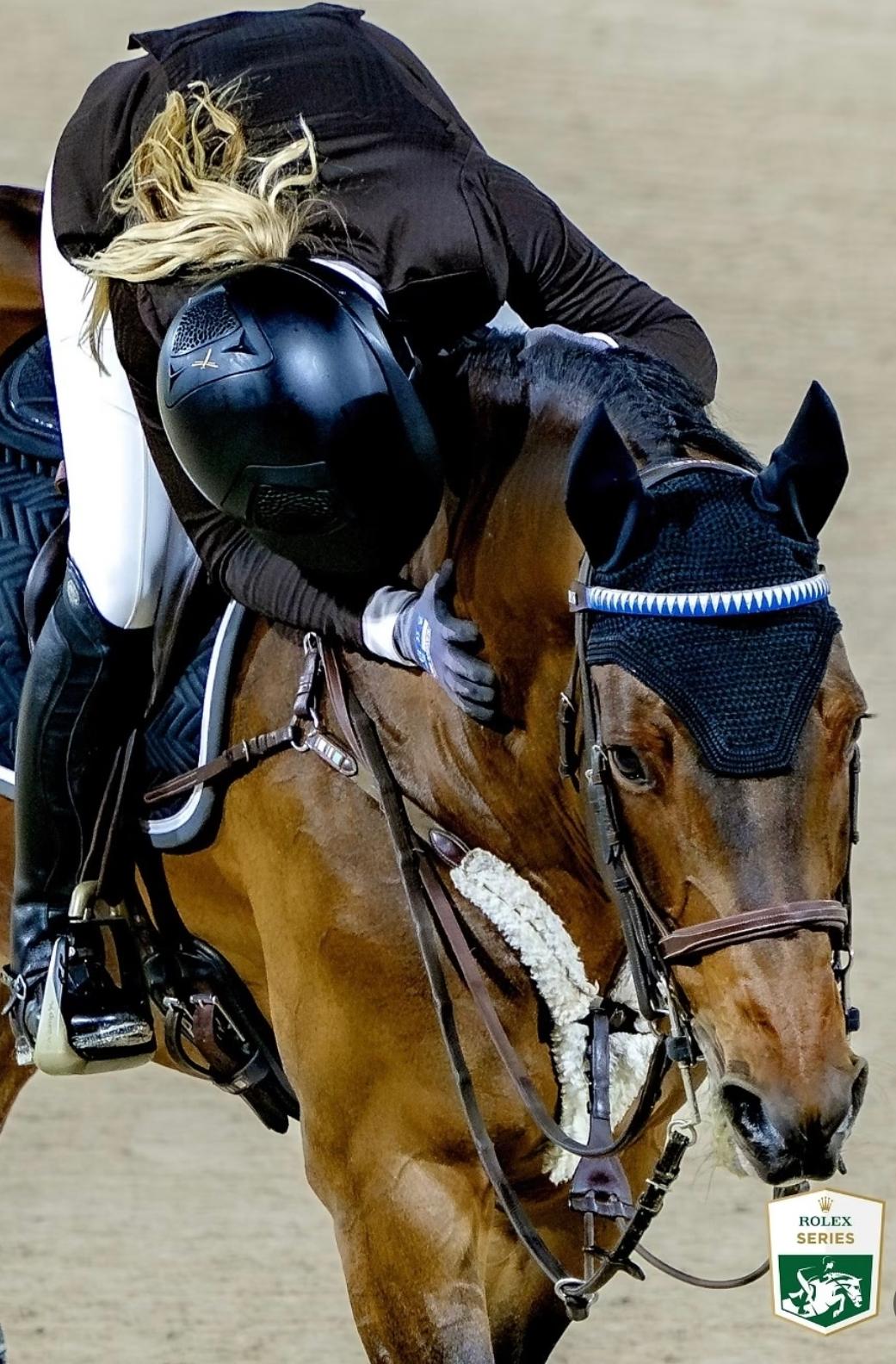 Ashlee leaning down to embrace her bay horse